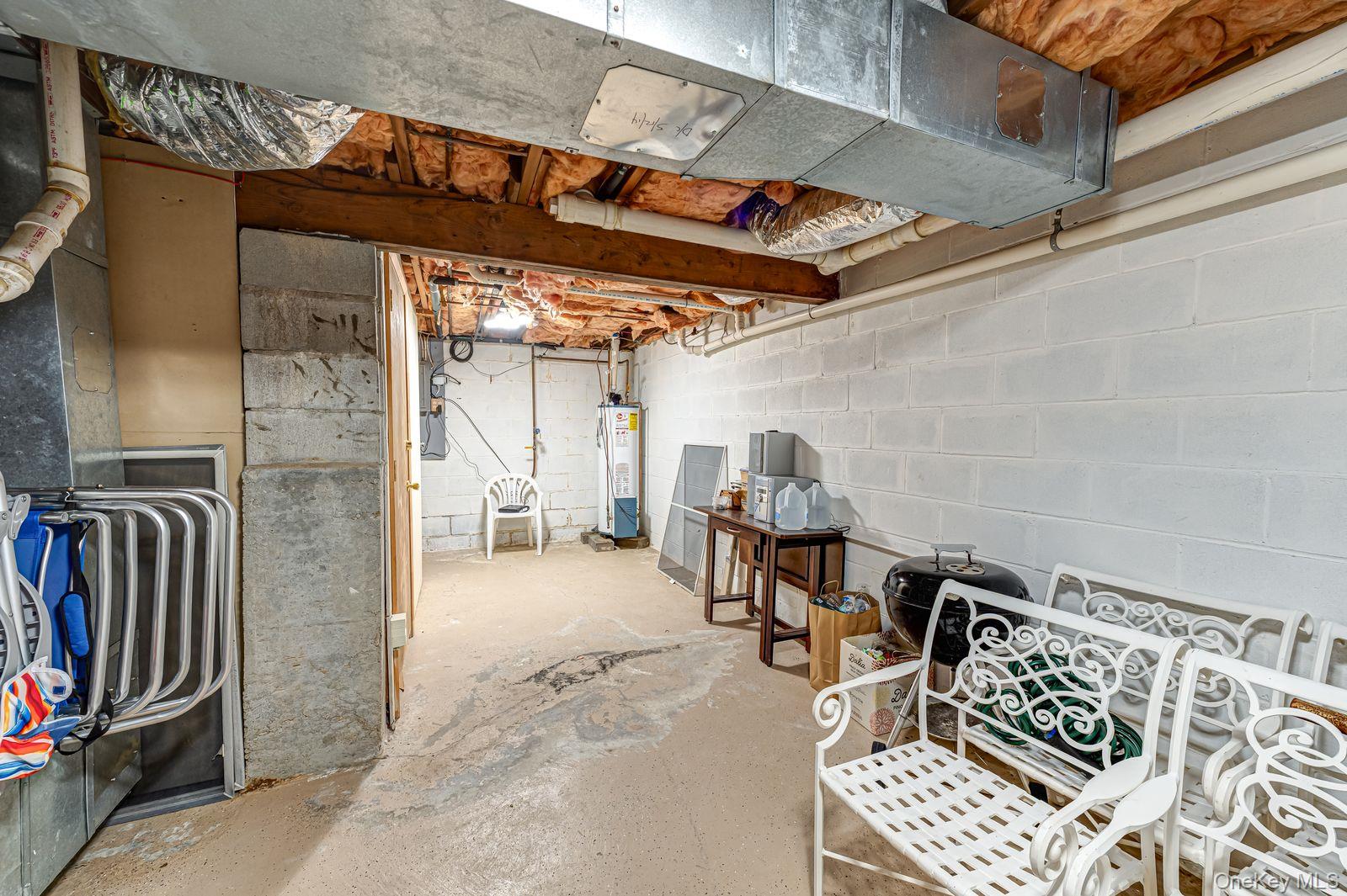 49 Canoe Place Road, Unit 212 Hampton Bays, NY 11946 - Photo 6 of 22 a view of a patio with table and chairs