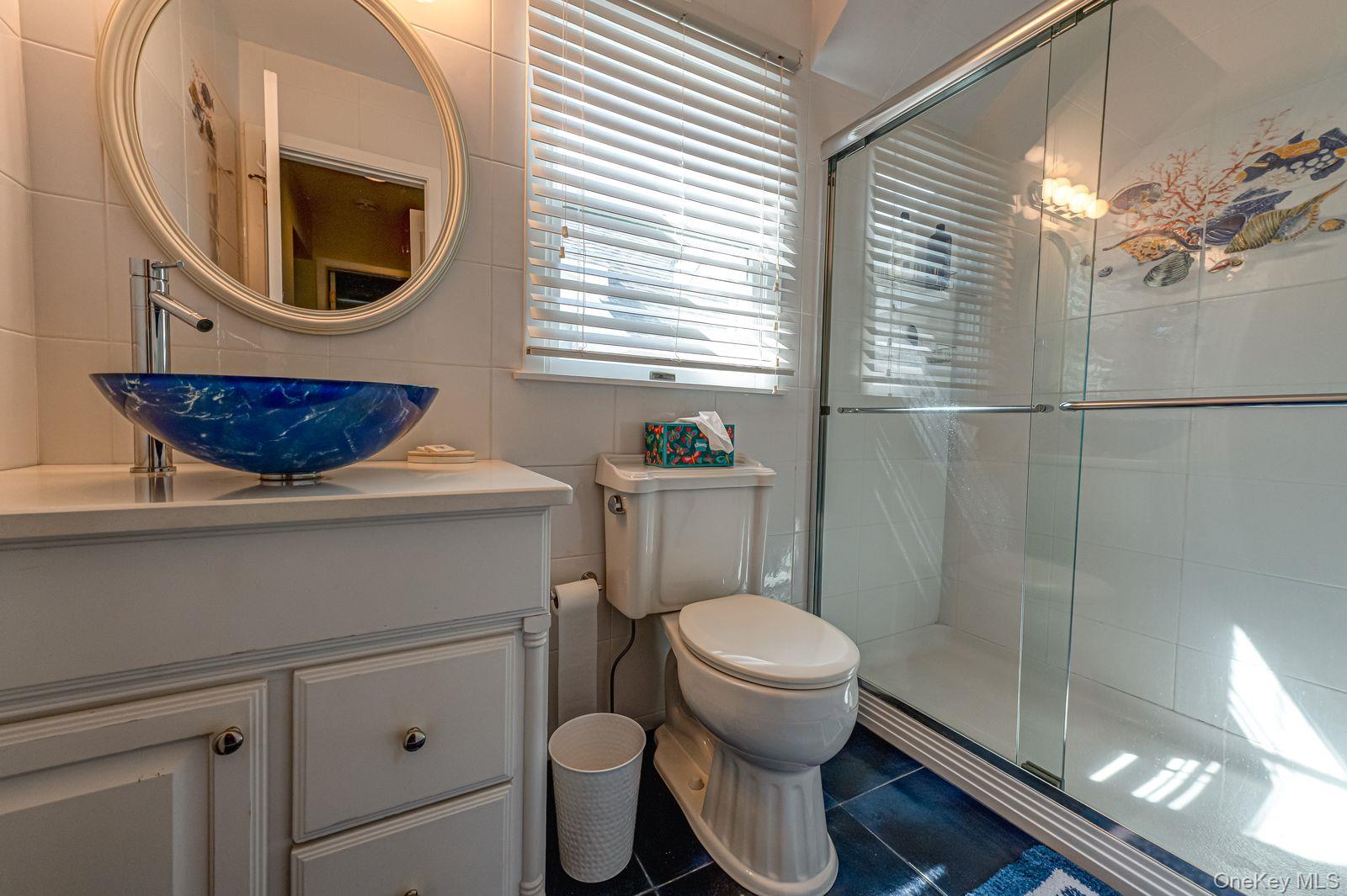 49 Canoe Place Road, Unit 212 Hampton Bays, NY 11946 - Photo 7 of 22 a bathroom with a toilet a sink and a window