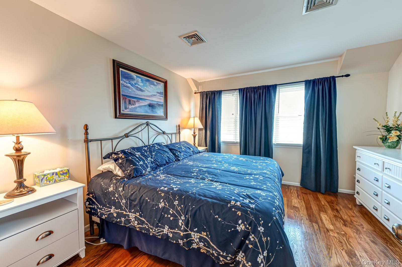 49 Canoe Place Road, Unit 212 Hampton Bays, NY 11946 - Photo 9 of 22 a bedroom with a bed and a dresser