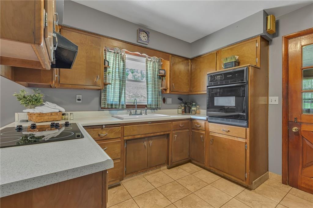 383 Ridgemont Drive Midland, PA 15059 - Photo 24 of 44 a kitchen with stainless steel appliances granite countertop a sink stove and refrigerator