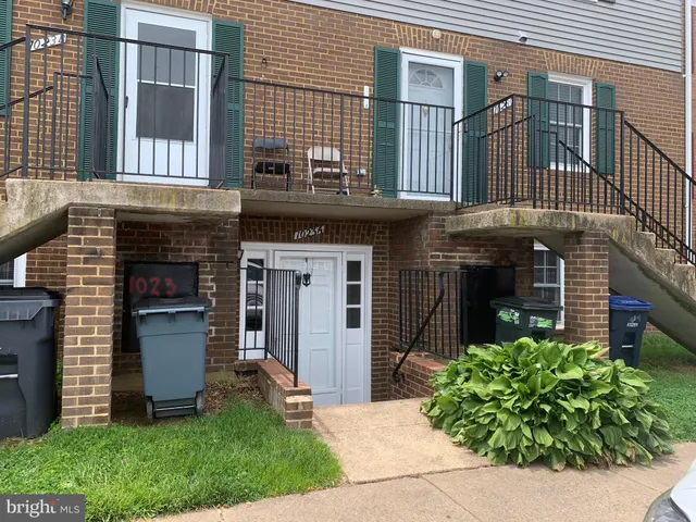 a view of a house with a small yard and a large window