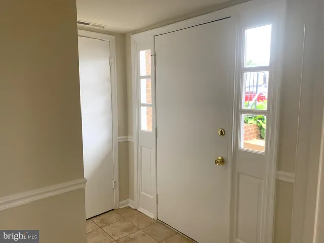 a view of an entryway with wooden floor