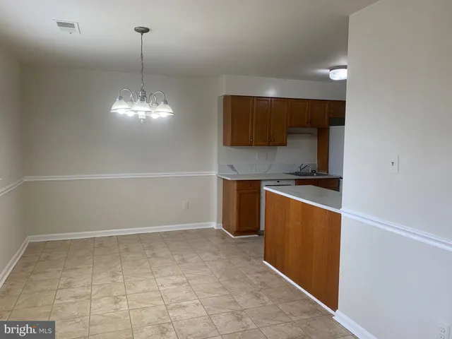 a kitchen with stainless steel appliances a refrigerator and microwave