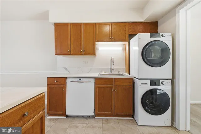 a utility room with sink dryer and washer
