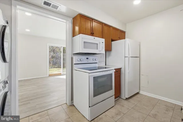 a kitchen with cabinets and steel stainless steel appliances