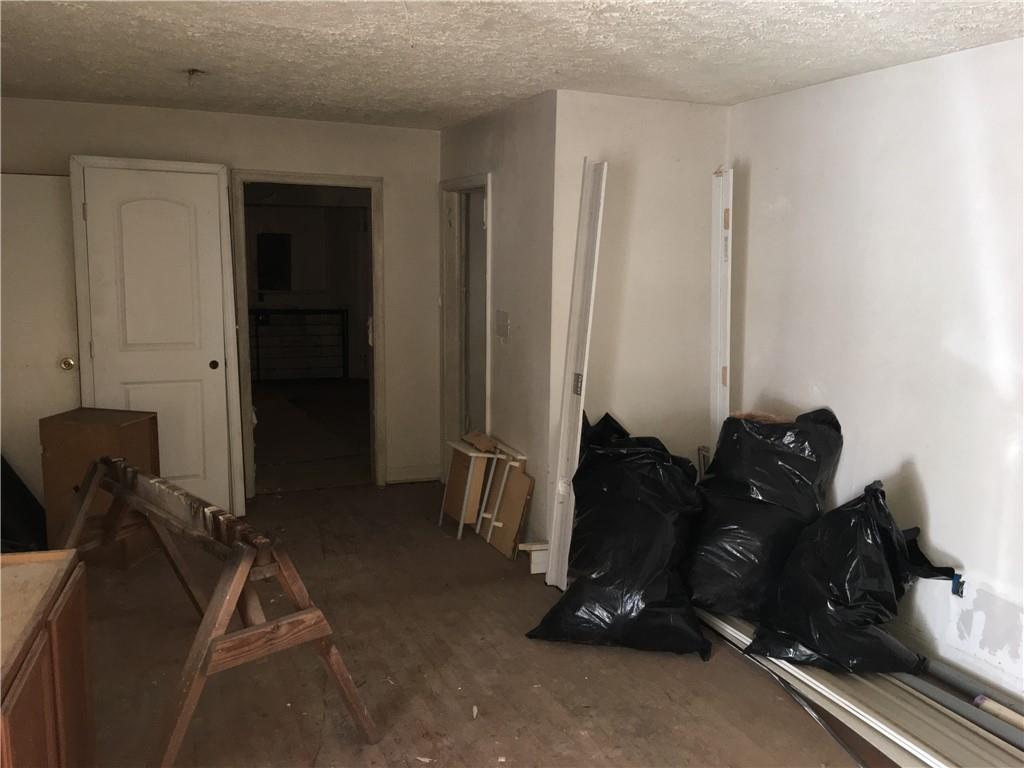 1220 Westmont Road Southwest Atlanta, GA 30310 - Photo 2 of 5 a living room with a bed a couch and a dresser