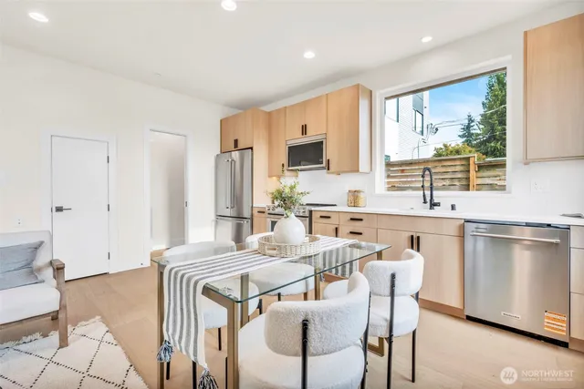 a living room with furniture a dining table and kitchen view