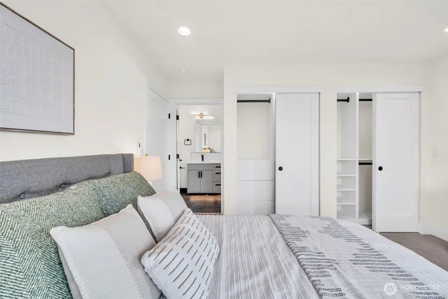 a bathroom with a sink a toilet a mirror and shower