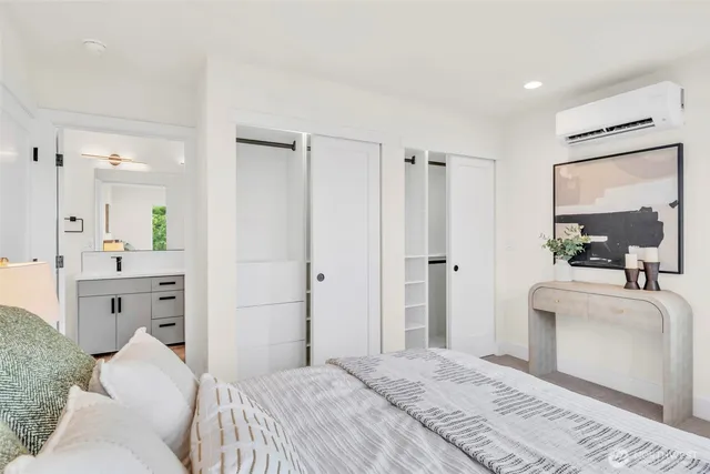 a bed sitting in a bedroom next to a window