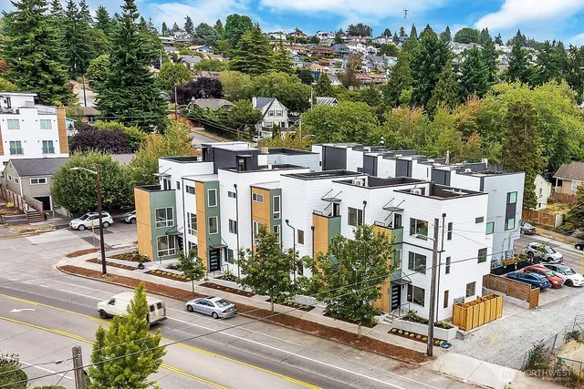 an aerial view of residential houses with outdoor space and street view