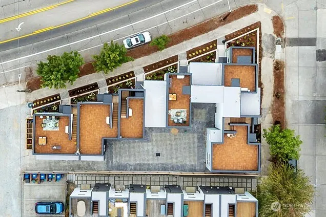 a view of a building with potted plants and a pathway