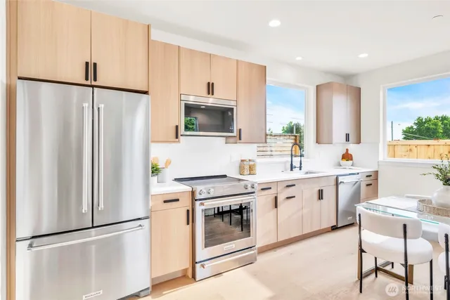 a kitchen with a sink stove and refrigerator