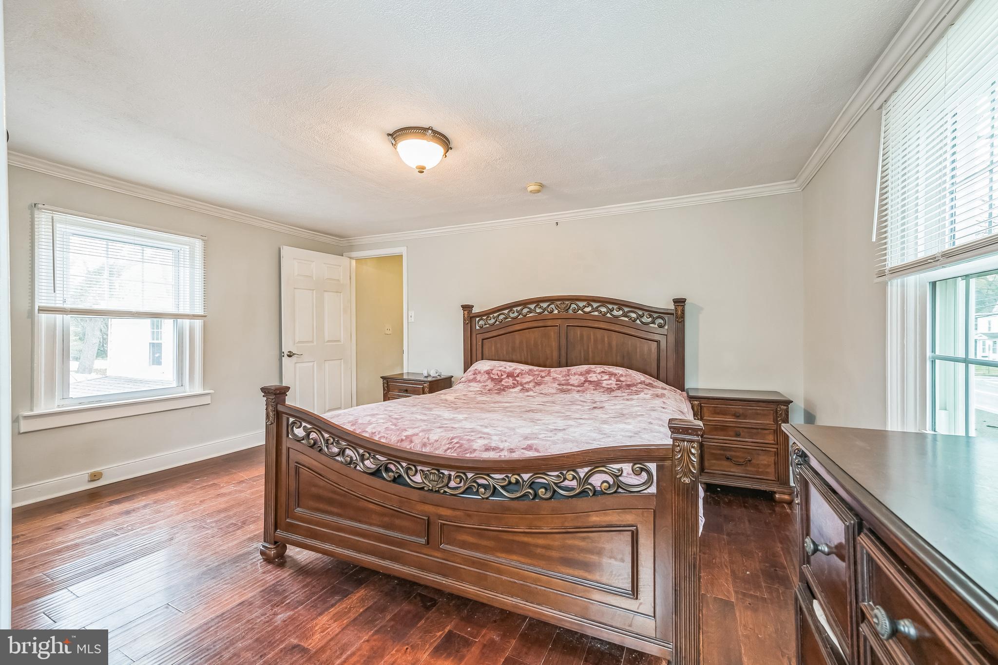 165 Warren Street Beverly, NJ 08010 - Photo 17 of 26 a bedroom with a bed and windows