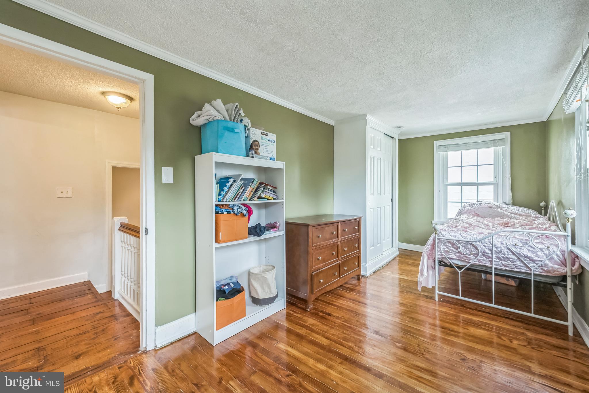 165 Warren Street Beverly, NJ 08010 - Photo 19 of 26 a bedroom with a bed and a dresser
