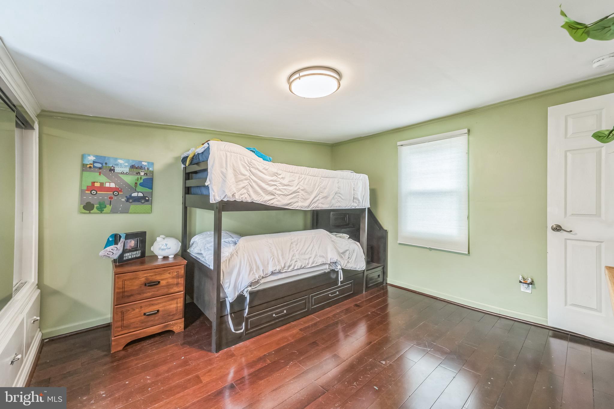 165 Warren Street Beverly, NJ 08010 - Photo 21 of 26 a bed room with a bed and a tv