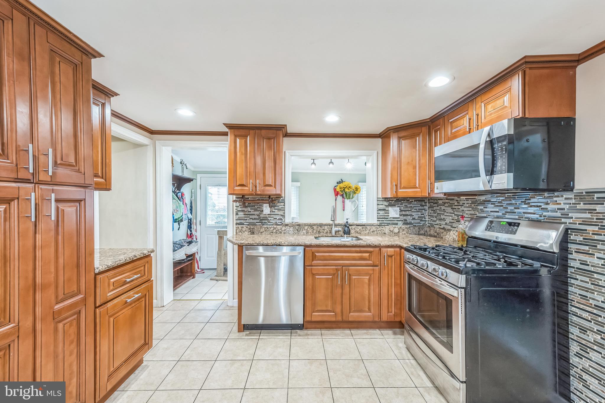165 Warren Street Beverly, NJ 08010 - Photo 3 of 26 a kitchen with stainless steel appliances granite countertop a stove top oven sink and cabinets