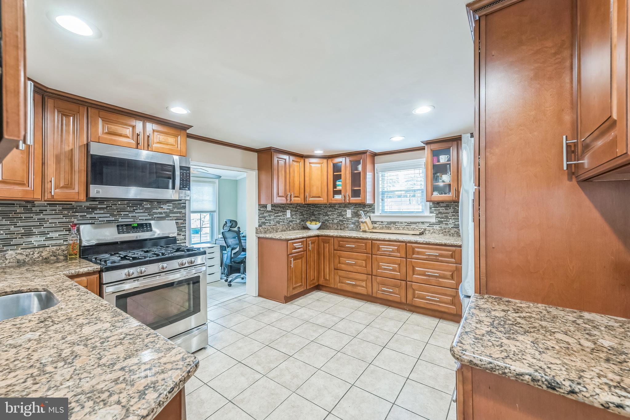 165 Warren Street Beverly, NJ 08010 - Photo 4 of 26 a kitchen with stainless steel appliances kitchen island granite countertop a stove a sink and a microwave