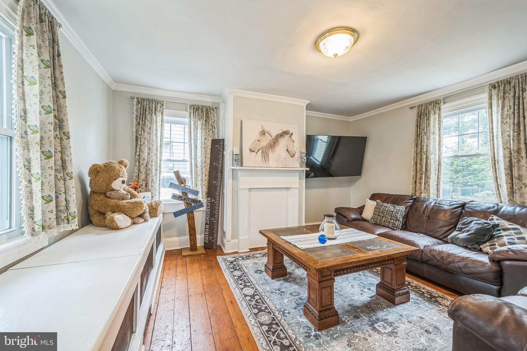 165 Warren Street Beverly, NJ 08010 - Photo 5 of 26 a living room with furniture and a flat screen tv