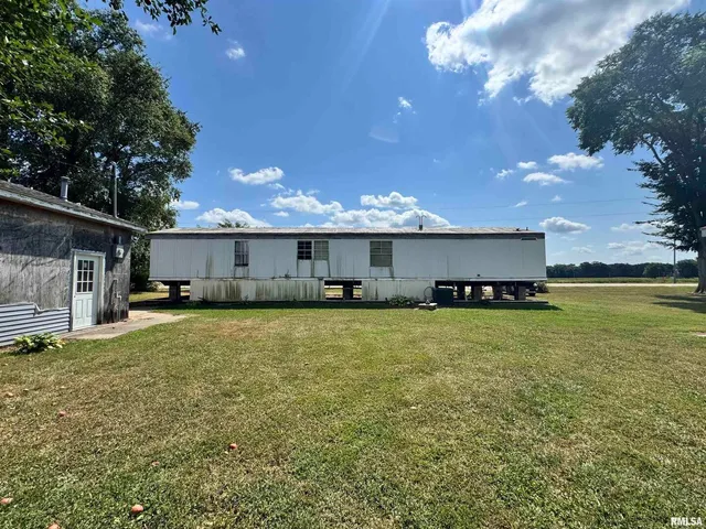 a front view of a house with a garden and yard