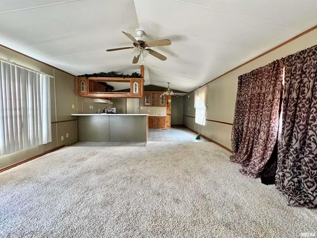a view of a kitchen with a stove cabinets and a ceiling fan