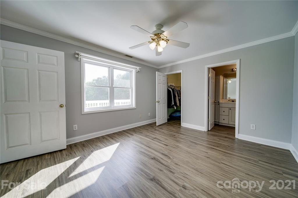 6460 Talley Road Stanfield, NC 28163 - Photo 11 of 47 a view of an empty room with wooden floor and a window