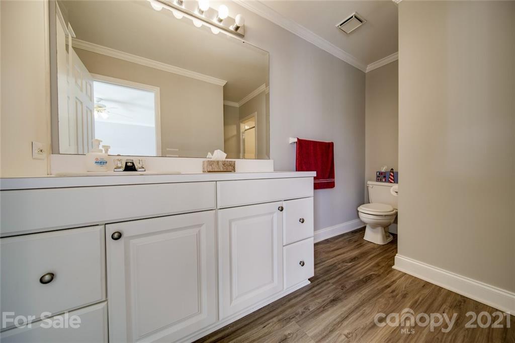 6460 Talley Road Stanfield, NC 28163 - Photo 12 of 47 a bathroom with a double vanity sink toilet and a mirror