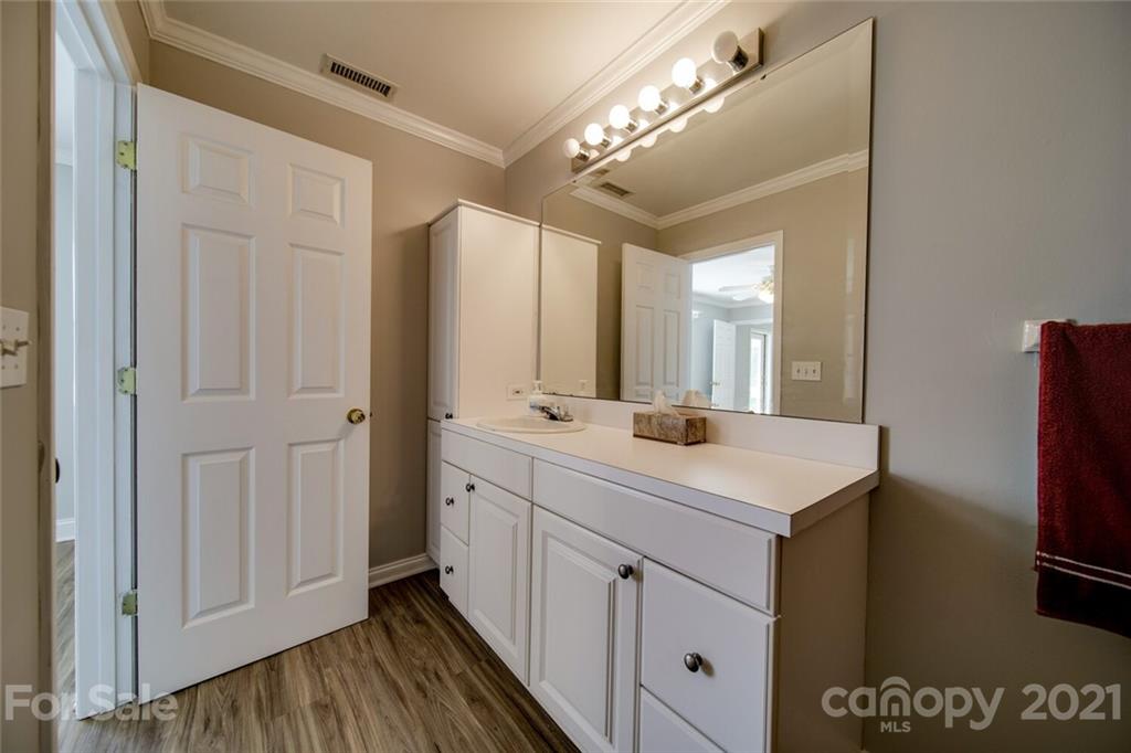 6460 Talley Road Stanfield, NC 28163 - Photo 14 of 47 a bathroom with a sink a mirror and a shower