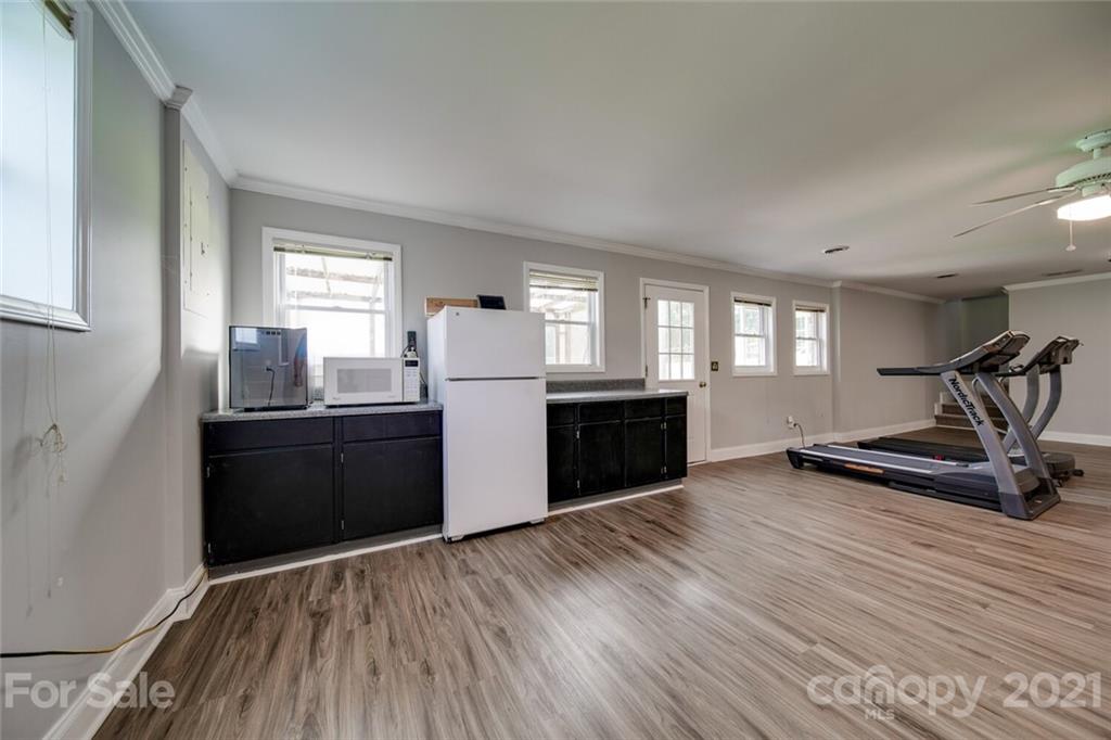 6460 Talley Road Stanfield, NC 28163 - Photo 18 of 47 a view of a kitchen with wooden floor and electronic appliances