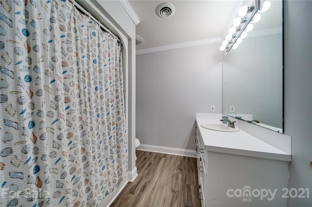 6460 Talley Road Stanfield, NC 28163 - Photo 19 of 47 a bathroom with a sink a mirror and shower curtain
