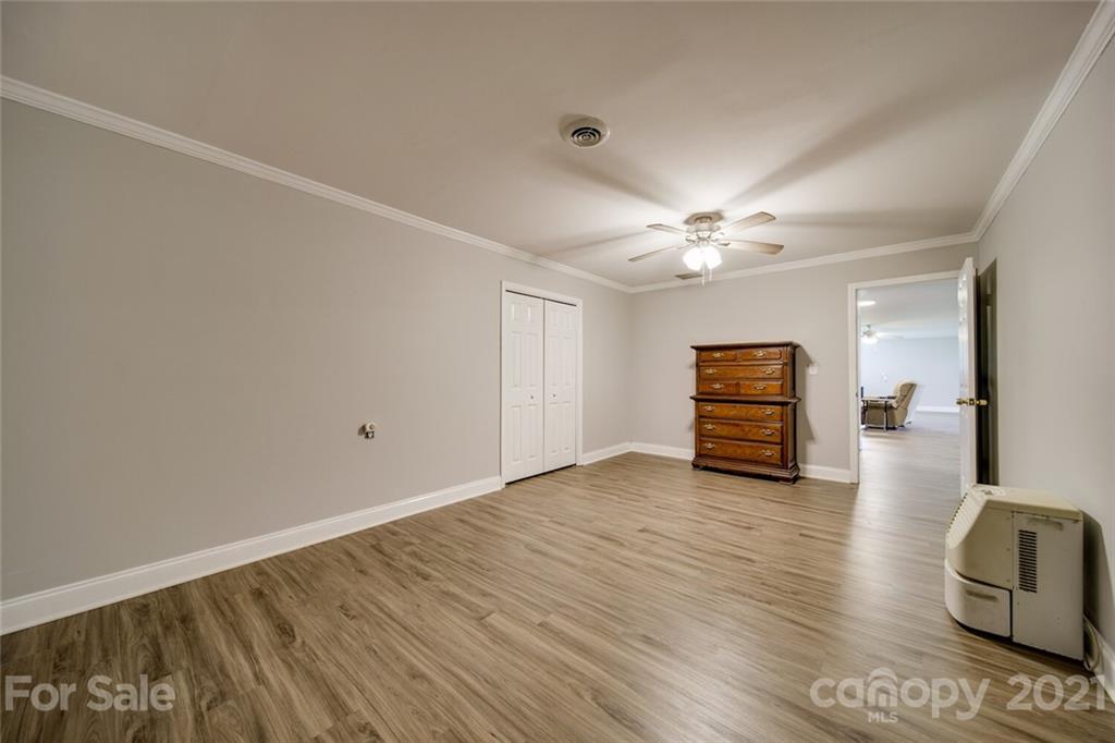 6460 Talley Road Stanfield, NC 28163 - Photo 21 of 47 a view of a livingroom with wooden floor and a ceiling fan