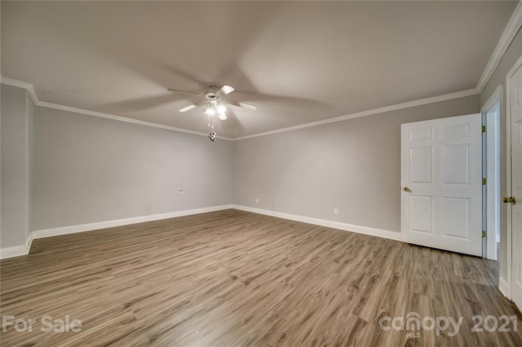 6460 Talley Road Stanfield, NC 28163 - Photo 22 of 47 a view of an empty room with wooden floor