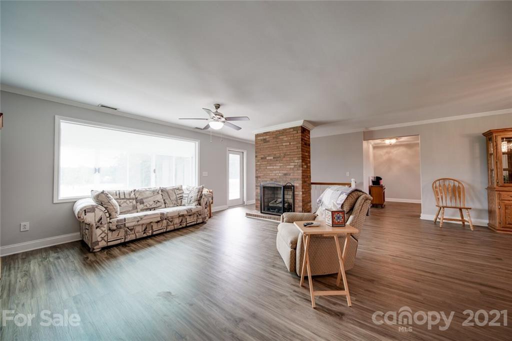 6460 Talley Road Stanfield, NC 28163 - Photo 28 of 47 a living room with furniture and a wooden floor