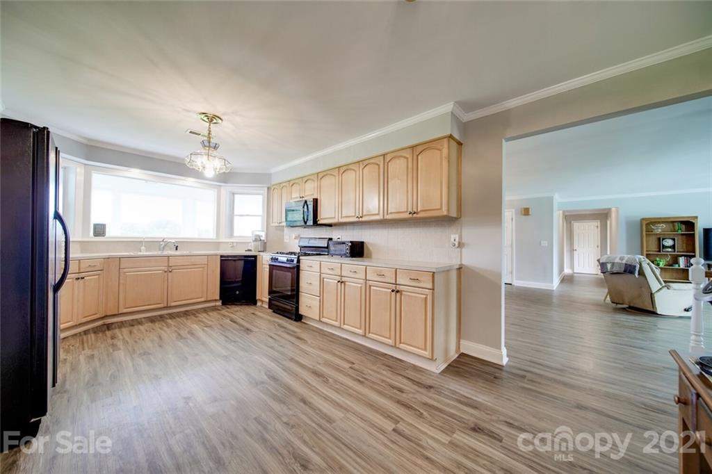 6460 Talley Road Stanfield, NC 28163 - Photo 33 of 47 a kitchen with white cabinets and white appliances