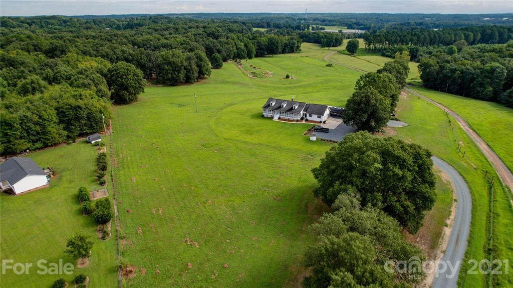 6460 Talley Road Stanfield, NC 28163 - Photo 5 of 47 an aerial view of a residential houses with outdoor space and trees all around