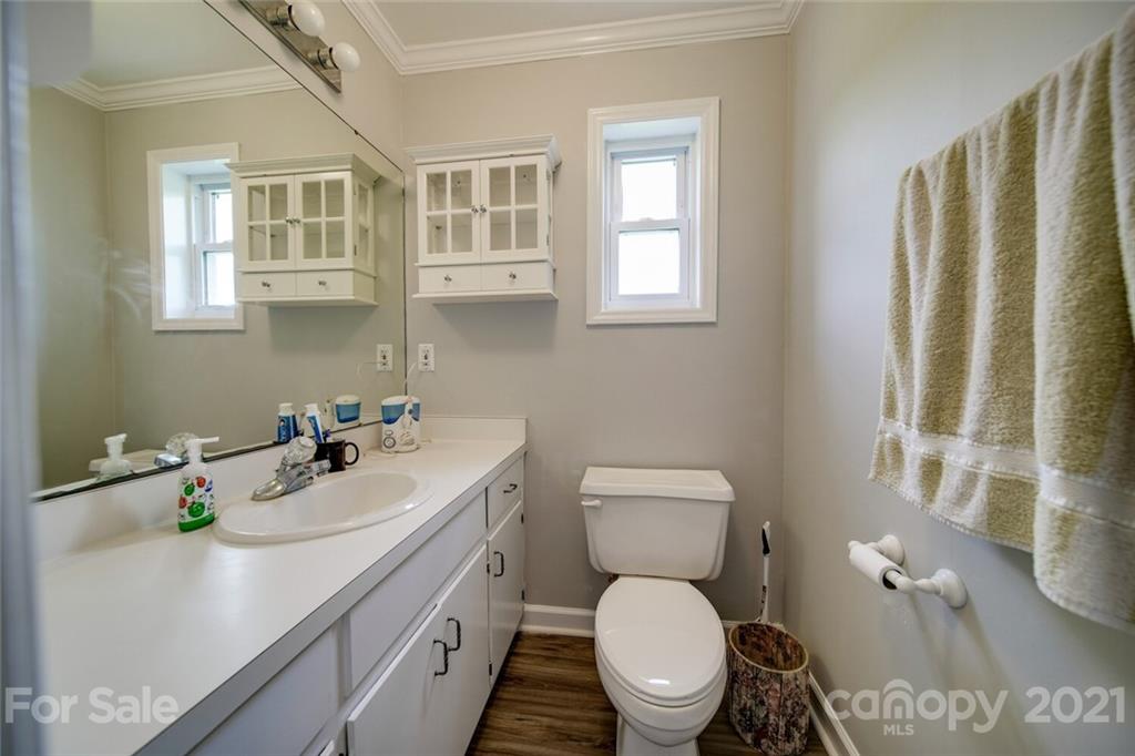 6460 Talley Road Stanfield, NC 28163 - Photo 41 of 47 a bathroom with a sink toilet and window