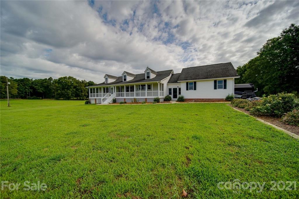 6460 Talley Road Stanfield, NC 28163 - Photo 45 of 47 a view of a house with a big yard and large trees