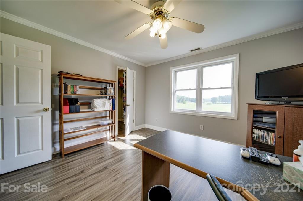 6460 Talley Road Stanfield, NC 28163 - Photo 6 of 47 a workspace with wooden floor cabinet and windows