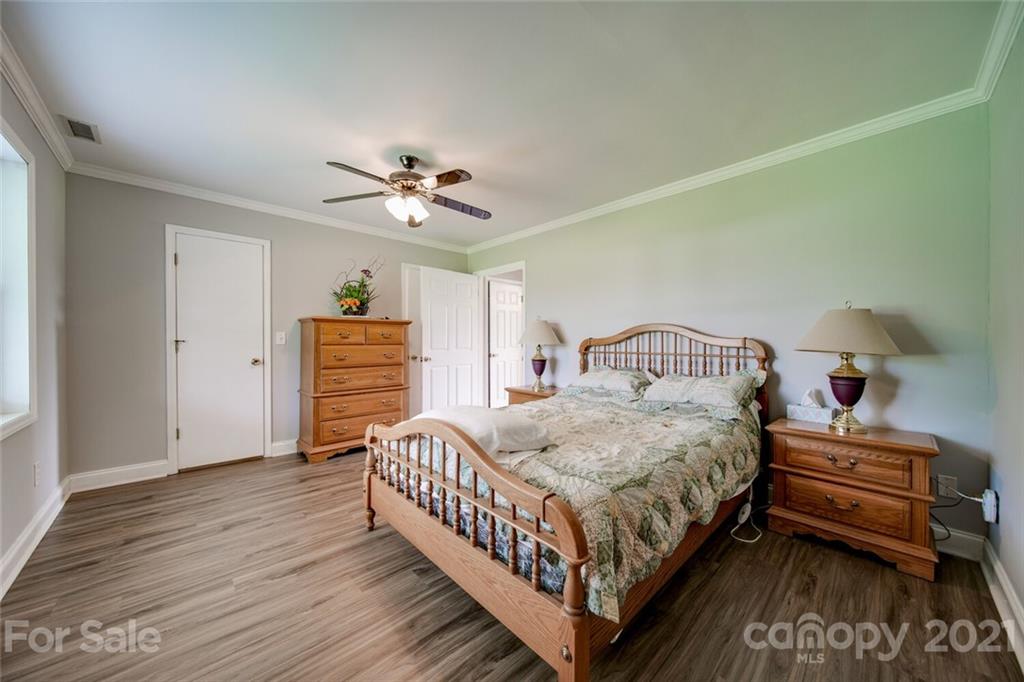 6460 Talley Road Stanfield, NC 28163 - Photo 9 of 47 a bedroom with a bed and a ceiling fan