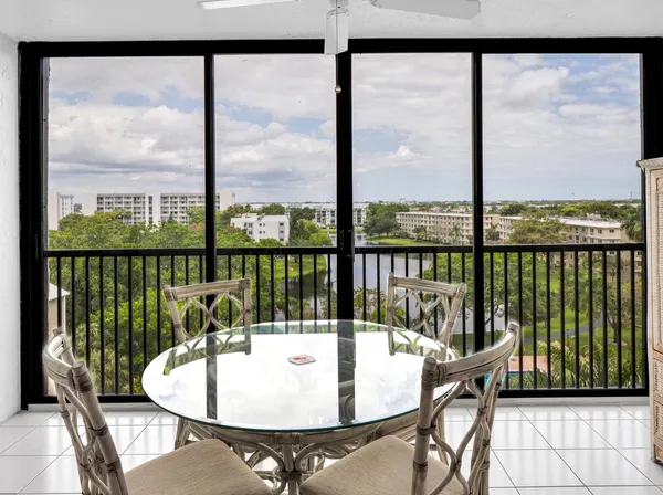 a dining room with furniture window and outside view