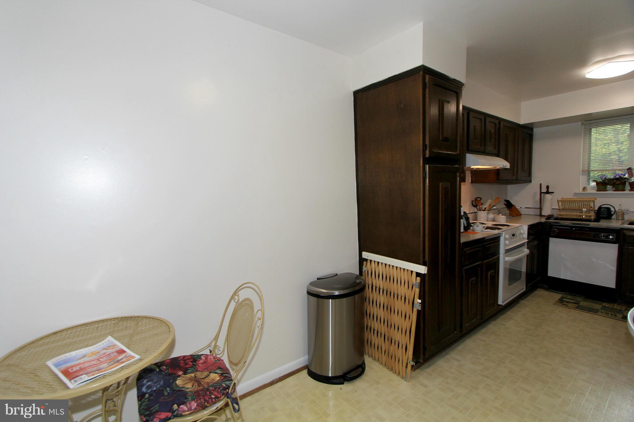 11051 Saffold Way Reston, VA 20190 - Photo 12 of 18 a kitchen with a refrigerator and a stove top oven