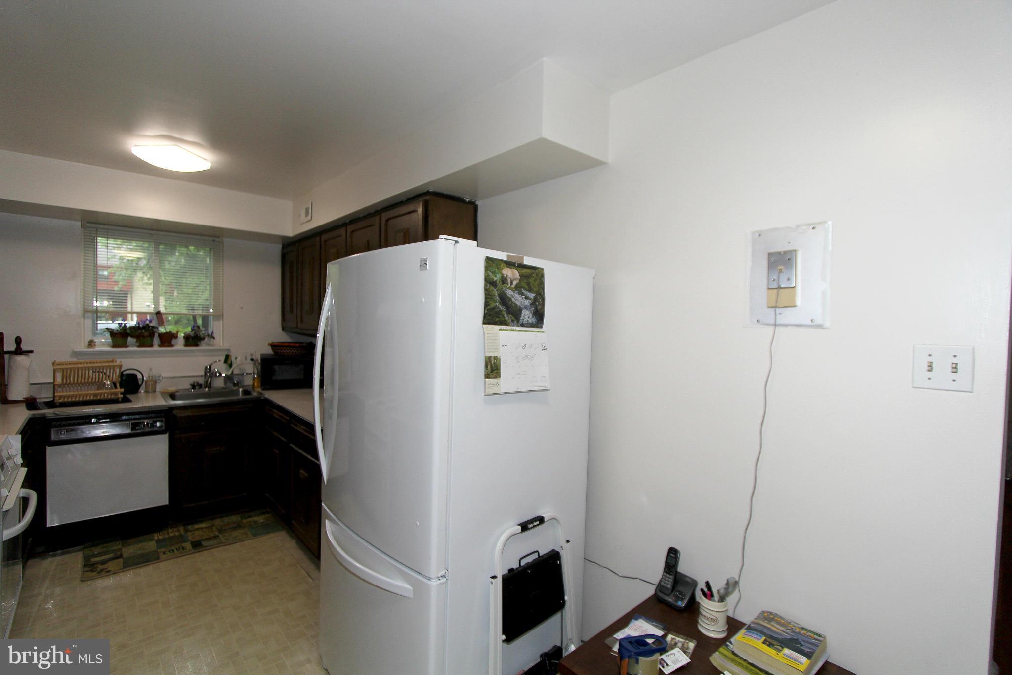 11051 Saffold Way Reston, VA 20190 - Photo 13 of 18 a kitchen with a refrigerator and a stove