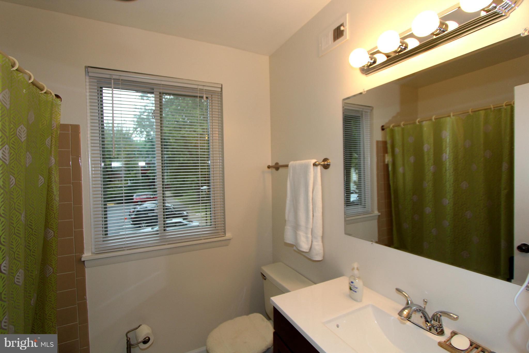 11051 Saffold Way Reston, VA 20190 - Photo 15 of 18 a bathroom with a sink mirror and a toilet