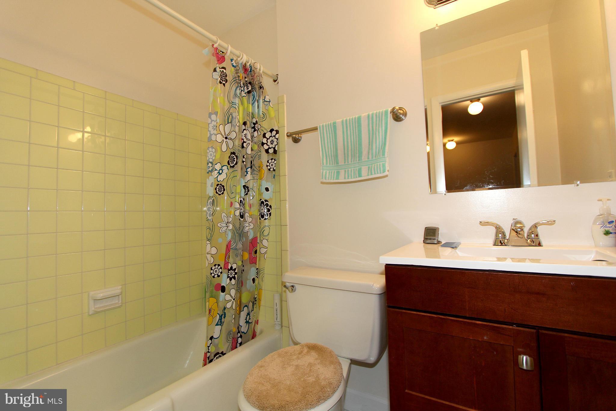 11051 Saffold Way Reston, VA 20190 - Photo 18 of 18 a bathroom with a sink toilet a shower and a mirror