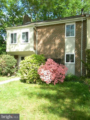 11051 Saffold Way Reston, VA 20190 - Photo 3 of 18 a front view of a house with garden