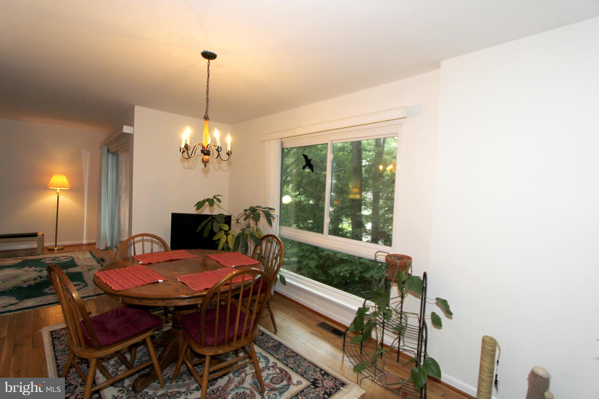 11051 Saffold Way Reston, VA 20190 - Photo 8 of 18 a view of a dining room with furniture window and outside view