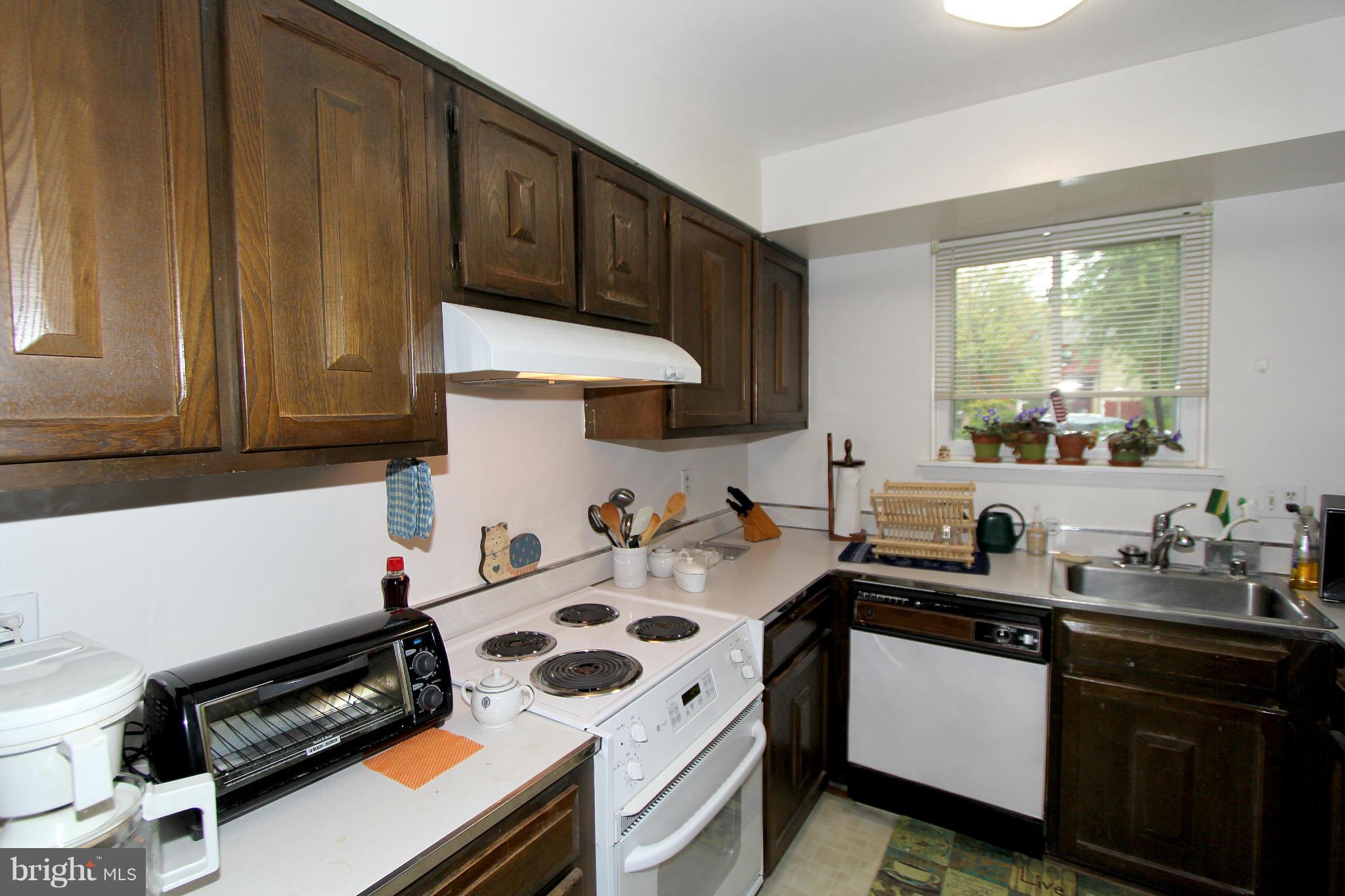 11051 Saffold Way Reston, VA 20190 - Photo 9 of 18 a kitchen with a sink a stove and a refrigerator