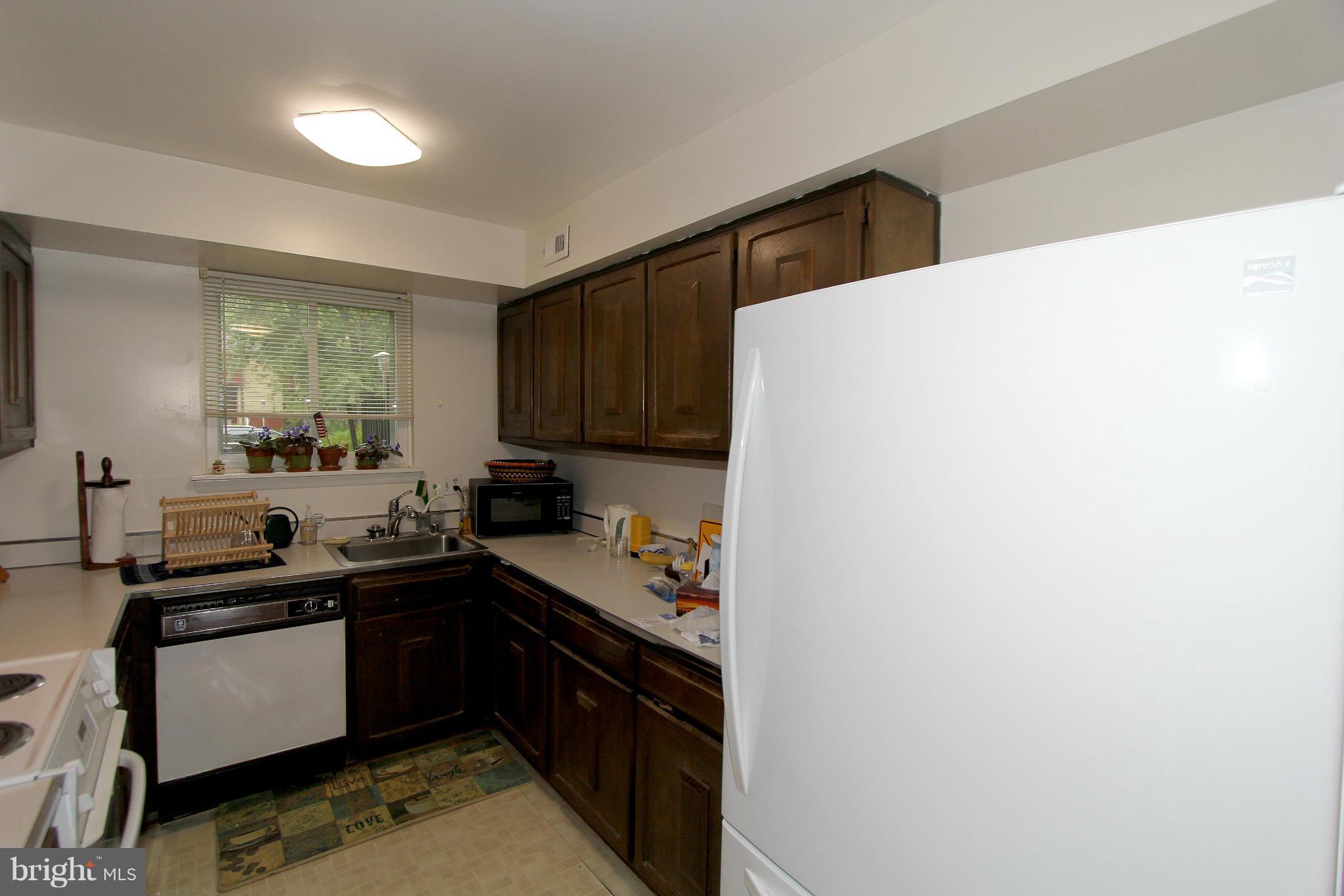11051 Saffold Way Reston, VA 20190 - Photo 10 of 18 a kitchen with a sink a stove and cabinets