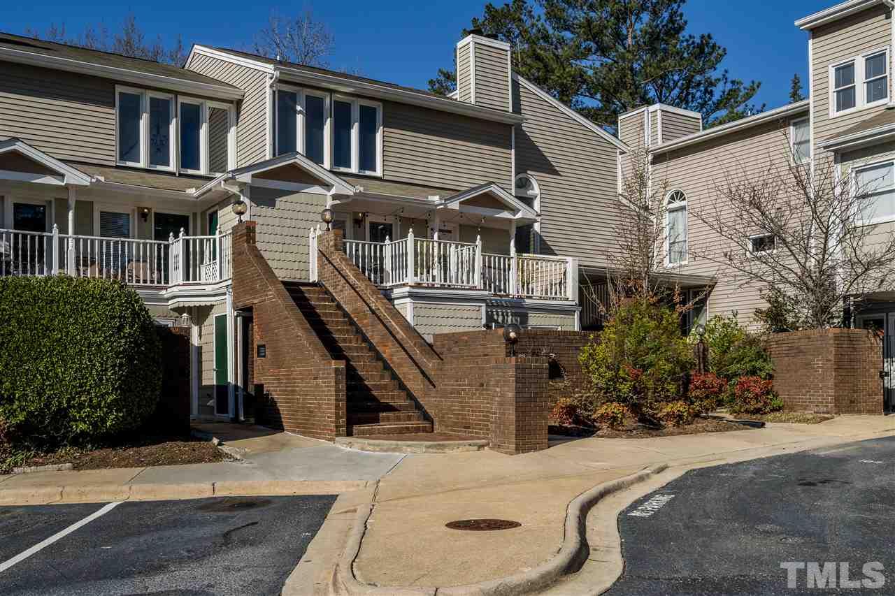 7010 Sandy Forks Road, Unit 207 Raleigh, NC 27615 - Photo 1 of 27 a front view of a house with a yard
