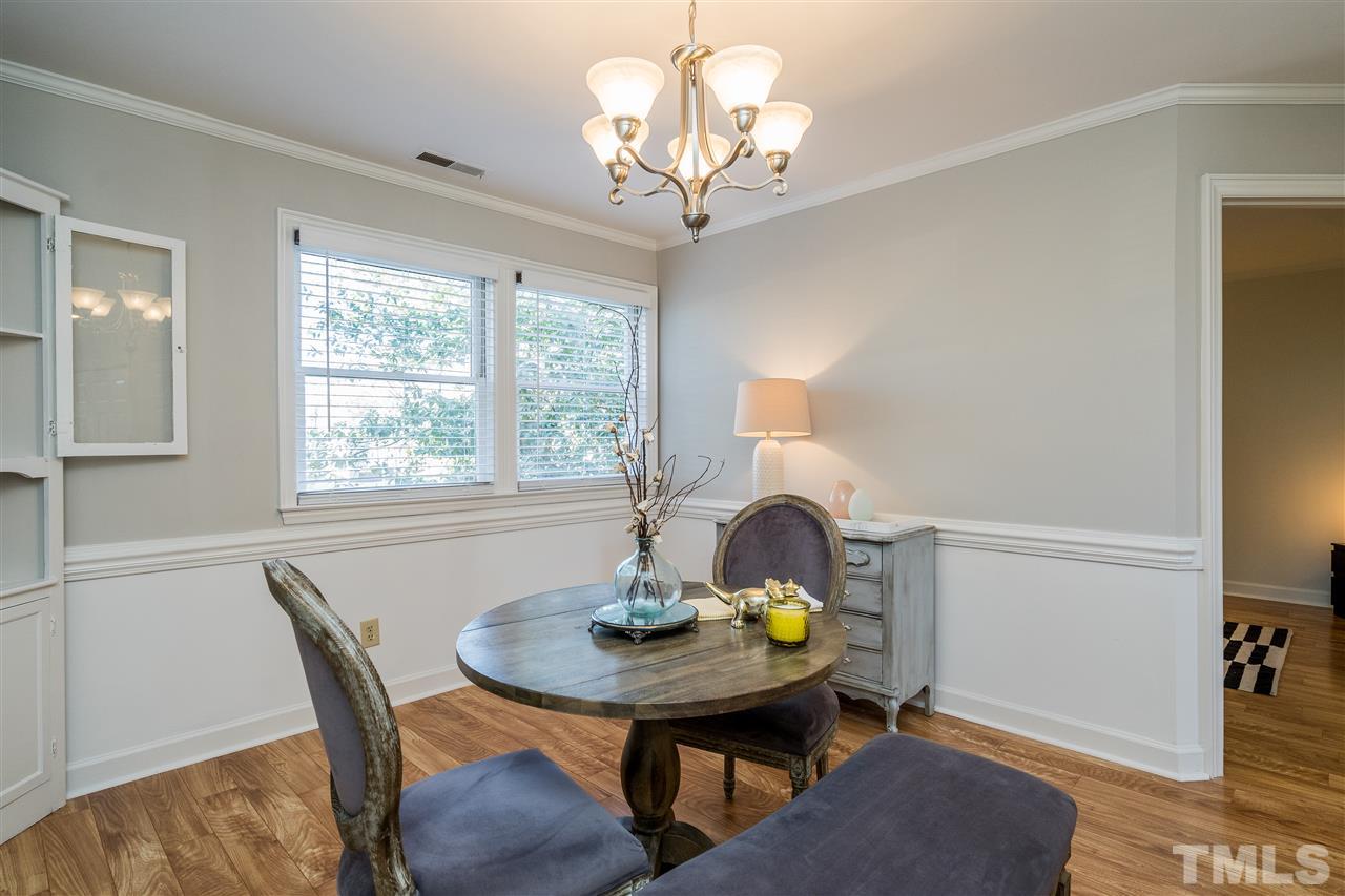 7010 Sandy Forks Road, Unit 207 Raleigh, NC 27615 - Photo 11 of 27 a view of a dining room with a table and chairs