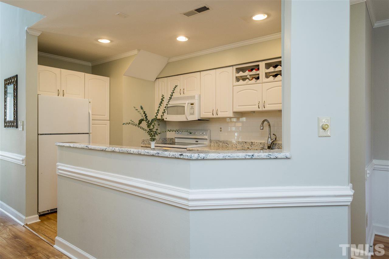 7010 Sandy Forks Road, Unit 207 Raleigh, NC 27615 - Photo 13 of 27 a view of kitchen with stainless steel appliances granite countertop cabinets and a refrigerator
